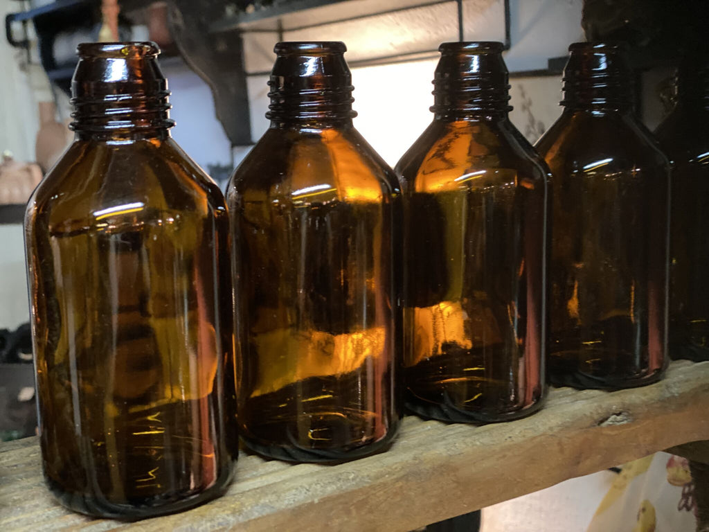Flaske i brunt glas Cemmi