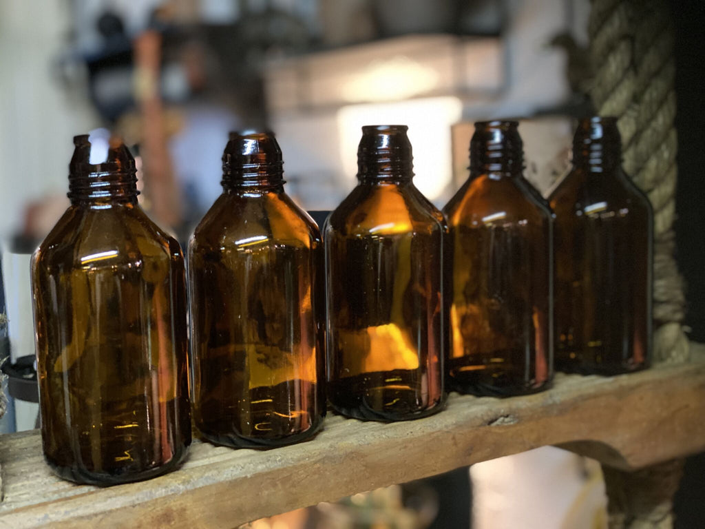 Flaske i brunt glas Cemmi